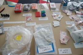 Materials on hand at the hackathon included components for hardware prototyping, moldable plastics, sewing, and 3-D printing. 