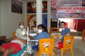 Lalani assists a local dentist with a tooth extraction in Lima.