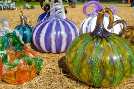 Glass pumpkins sit on the grass in front of MIT's Student Center