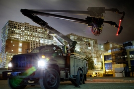 A Digital Construction Platform consists of a boom truck system repurposed for the 3D-printing of buildings.
