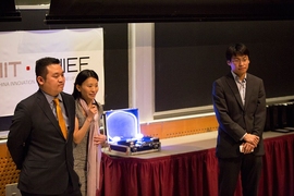 BelLEDs Technologies team members (left to right) Patrick Lin, Xiaolu Li, and Michael Chen deliver their pitch, complete with a working prototype of their smart LEDs (center, in the suitcase) that illuminated to the sound of music. 