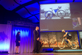 Terrainer, demonstrated by the blue team, converts a regular bicycle into a training bike by adding extra resistance to the wheels, displaying the cyclist’s level of exertion just as a stationary bicycle would in a gym. 