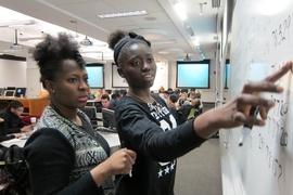 Ruka Aderogba (left), a psychology major at Hunter College, and Favour Akinjiyan, a biology major at the New York Institute of Technology, work together on a Python coding exercise.