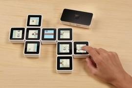 Among the games designed for the Sifteo Cubes were adventure games, like the one shown here, where users uncover sections of a maze for characters by moving cubes up and down, and putting them adjacent to each other.