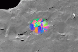 This scanning electron micrograph shows a sample of metal that fractured due to hydrogen embrittlement. The colored patches show data acquired by electron backscatter diffraction, revealing the grain structure surrounding selected cracks. Such images help show the correlation between microstructure and hydrogen embrittlement, and are used to identify the features that lead to hydrogen-assisted fra...