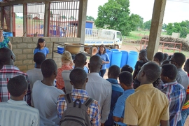 Xing, with teammate and MIT alumna Coyin Oh '14 and faculty supervisor Susan Murcott, demonstrating their system to fourth-year students from the University of Development Studies at Tamale, Ghana.