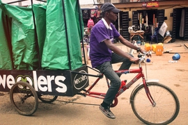 An employee rides one of the Wecyclers' cargo bikes. The startup employs locals to ride door-to-door across the slums of Lagos, Nigeria, to collect recyclables.