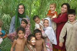 Christia stands with children from a village in Nangarhar, Afghanistan, in the summer of 2009.