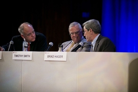 The anti-divestment team, conferring on their response to a question, consisted of (from left) Frank Wolak, professor of economics at Stanford University; Timothy Smith of Walden Asset Management; and Brad Hager, director of the MIT Earth Resources Laboratory. 