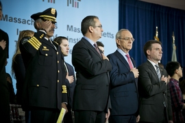 During the Pledge of Allegiance at today's dedication of the Collier Memorial: (from left) John DiFava, MIT's director of campus services and chief of police; Cambridge Mayor David Maher; MIT President L. Rafael Reif; and MIT Executive Vice President and Treasurer Israel Ruiz.