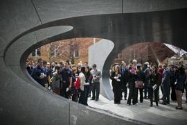 The smooth, curved vault of the granite memorial is supported by five radial walls. Members of the MIT community gathered around and inside the structure following today's ceremony.