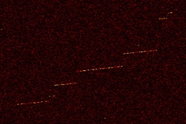 Shown here is "event zero," the first detection of a trapped electron in the MIT physicists' instrument. The color indicates the electron's detected power as a function of frequency and time. The sudden “jumps” in frequency indicate an electron collision with the residual hydrogen gas in the cell.