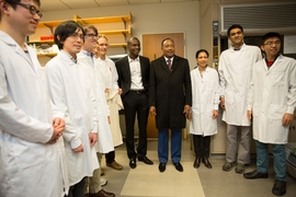 Cissé (center, left) stands with Issoufou (center, right), along with a group of postsoc and PhD researchers