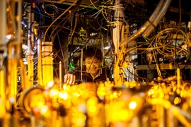 Graduate student Lawrence Cheuk adjusts the optics setup for laser cooling of sodium atoms.