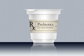 Sealed cup sits atop reflective surface with a prescription label and text that reads "Probiotics" and "Use: cancer detection".