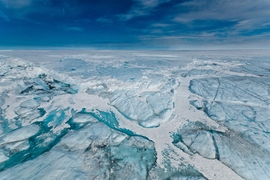 A water-filled hydro-fracture and ice blocks remain after a supraglacial lake drained on Greenland's ice sheet in 2011.