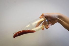 Ketchup slides out of a bottle that's been coated with LiquiGlide.