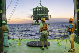 Researchers deploy the Niskin bottle rosette that is used for collecting the thorium samples at sunset.