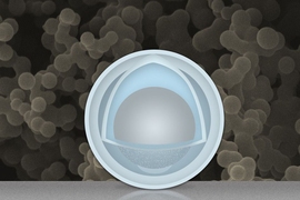 A new "yolk-and-shell" nanoparticle from MIT could boost the capacity and power of lithium-ion batteries. The gray sphere at center represents an aluminum nanoparticle, forming the "yolk." The outer light-blue layer represents a solid shell of titanium dioxide, and the space in between the yolk and shell allows the yolk to expand and contract without damaging the shell. In the background is an act...
