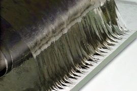 Engineered hydrogel being pulled away from a glass surface. The material shows a property called “tough wet adhesion” comparable to tendon and bone interface. The wavy edge instability at the interface is a hallmark of strongly adhered soft material on a rigid surface.