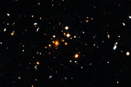 Astronomers have detected a massive, sprawling, churning galaxy cluster that formed only 3.8 billion years after the Big Bang. The cluster, shown here, is the most massive cluster of galaxies yet discovered in the first 4 billion years after the Big Bang. 