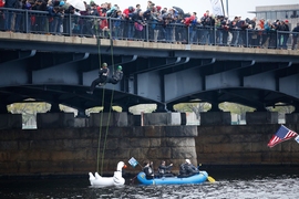 MIT students and staff members rappelled off the bridge over the Charles River, as part of the “Crossing the Charles” procession and competition.