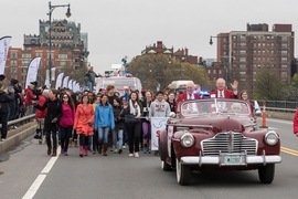MIT's "Crossing the Charles" procession and competition was a featured part of the Institute's Moving Day festivities, May 7, 2016. Here, grand marshall Oliver Smoot '62 (right) rides at the front of the parade.