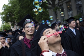 Student blows bubbles at MIT Commencement
