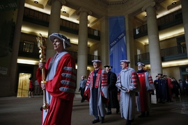 MIT Alumni Association President John Chisholm ’75, SM ’76 led the Academic Procession through Lobby 7, carrying the golden ceremonial mace.