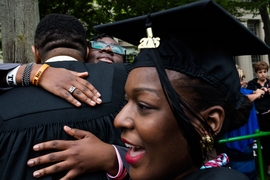 Family hugs their child who is graduating from MIT