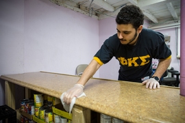 Alexis Cuellar, a biological engineering senior, was one of three Phi Kappa Sigma fraternity brothers who spent the afternoon cleaning the Margaret Fuller Neighborhood House’s food pantry.