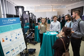 Throughout Saturday afternoon, 40 competing teams showcased innovations in the MIT Media Lab. Pictured: Emily Lindemer (left) and Vincent Valant (on her left) of Hey, Charlie, an addiction-recovery app that won the top $15,000 prize.