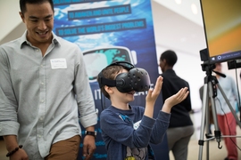 An attendee takes a virtual tour of a flooded Florida coast, with technology from Before It's Too Late, a team creating virtual-reality simulations that demonstrate the impact of climate change on the world.