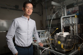 XiaoYu Wu pictured with the reactor his team used for the research. MIT researchers have developed a new system that could potentially be used for converting power plant emissions of carbon dioxide into useful fuels. The method may not only cut greenhouse emissions; it could also produce another potential revenue stream to help defray its costs.
