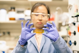 MIT postdoc, Grace Han, handles a new chemical composite that could provide an alternative to fuel by functioning as a kind of thermal battery. 
