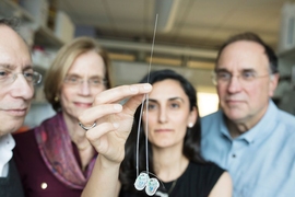 Dagdeviren (center) developed the device while working as a postdoc in the labs of Graybiel (left), Cima (right), and Langer (far left).
