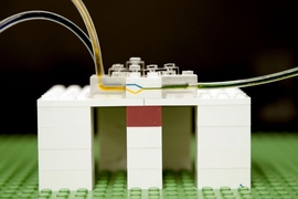 MIT researchers have developed a new platform for microfluidics, using LEGO bricks. Shown here, fluid flows through tiny channels milled into the side walls of LEGO bricks.