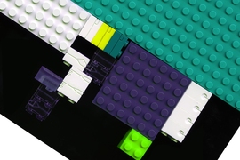 A close-up of LEGO bricks, milled with tiny fluidic channels.