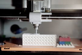 MIT researchers used a desktop micromilling machine to drill small channels into the sidewalls of LEGO bricks.
