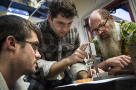 Professor Alex Slocum (right) works with students Alban Cobi and Steven Link, who are developing an adjustable phantom for radiotherapy validation.
