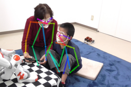 An example of a therapy session augmented with humanoid robot NAO [SoftBank Robotics], which was used in the EngageMe study. Tracking of limbs/faces was performed using the CMU Perceptual Lab's OpenPose utility.