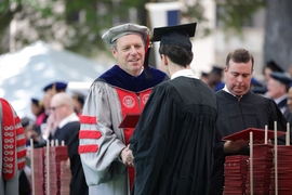 MIT Provost Martin Schmidt presented a diploma to an MIT graduate.
