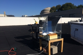 In this experiment, the new steam-generating device was mounted over a basin of water, placed on a small table, and partially surrounded by a simple, transparent solar concentrator. The researchers measured the temperature of the steam produced over the course of the test day, Oct. 21, 2017.