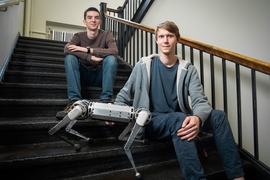 Benjamin Katz (right), a technical associate in mechanical engineering, and electrical engineering and computer science senior Jarod Di Carlo developed a robotic cheetah that can perform a backflip.
