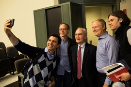 MIT Professor Manolis Kellis, left, takes a photo with Gerald Fink, center, recipient of the 2018-2019 James R. Killian Jr. Faculty Achievement Award. 