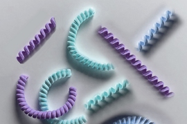 MIT engineers have designed coiled “nanoyarn,” shown as an artist’s interpretation here. The twisted fibers are lined with living cells and may be used to repair injured muscles and tendons while maintaining their flexibility. 