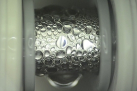 Specialized thin coatings developed by the MIT team cause even low-surface-tension fluids to readily form droplets on the surface of a pipe, as seen here, which improves the efficiency of heat transfer.