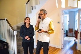 MIT economists Abhijit Banerjee (on the phone) and Esther Duflo receive a congratulatory call from a former student after their Nobel Prize is announced.