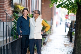 MIT economists Esther Duflo and Abhijit Banerjee stand outside their home. 