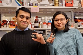 Senior postdoc Ameya Kirtane and technical associate Tiffany Hua show drug-releasing capsules that they tested for their ability to deliver contraceptive drugs.